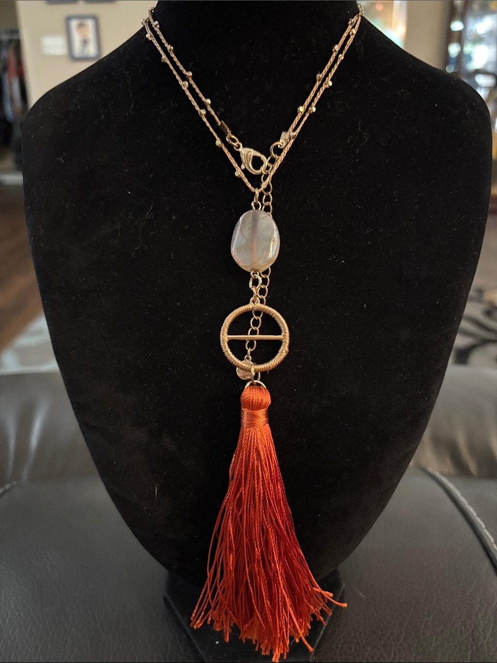 Gold-Tone Necklace with Pendant and Red Tassel Accent
